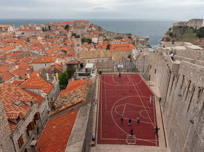 Old City Walls in Croatia overlooking a basketball court.