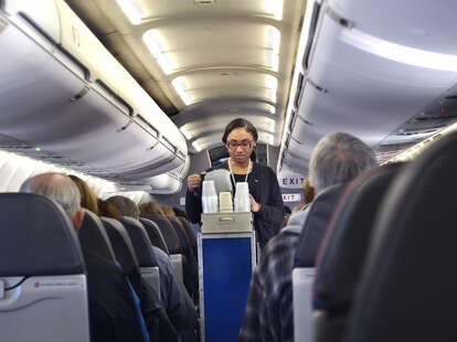 An American Airlines flight attendant serves drinks to passengers after departing from San Antonio International Airport in Texas.