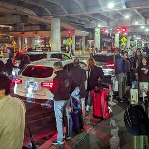 People waiting for rideshare transportation at JFK Airport