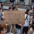 An anti-tourism placard is seen during the demonstration. More than 3,000 people demonstrated against the tourist overcrowding suffered by the city of Barcelona and in favor of tourism reduction policies. 