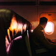 Passenger in the airplane looking at the window