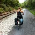 woman in washington biking on a trail accessed by bus without car