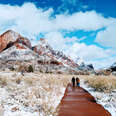 hikers ascending a snowy trail at zion national park 