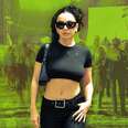 Charli XCX in front of a green backdrop. 