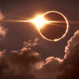 Total eclipse of the Sun, the moon covers the sun in a solar eclipse as seen through clouds